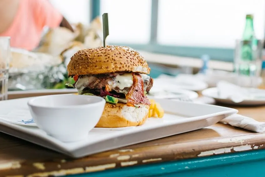 photo of a juicy burger in a fast food restaurant while eating out