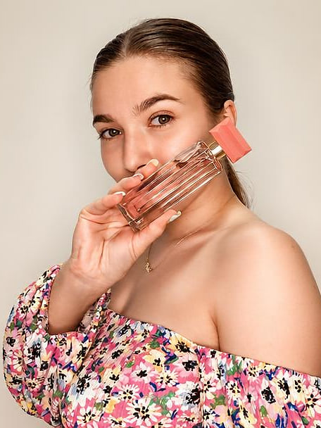 Creator fanning Oriflame lipsticks across her face